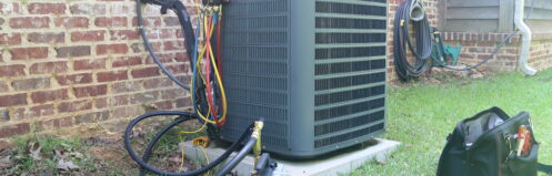 An AC unit in the backyard of a Middletown home getting maintenance.